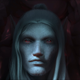 A vampire looks at the viewer from their coffin.